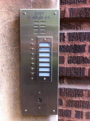 Stainless steel panel with postal switch (for mailman to get inside the building to deliver the mail)