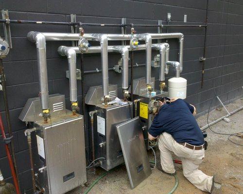 Technician working on Tankless Water Heaters