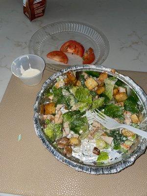 Large caesar salad (that came with tomatoes weirdly??) with grilled chicken to-go (I very much do not recommend)