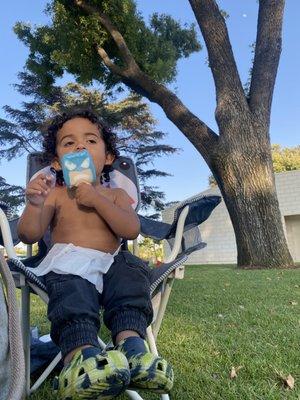 enjoying his first ever, ice cream from an ice cream truck after tons of fun in the splash zone!