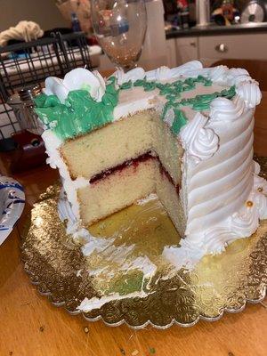 Inside of cake: white cake, raspberry filling, whipped cream frosting.