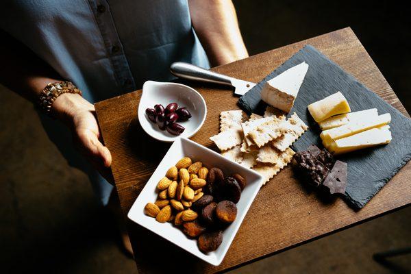 Enjoy a cheese board with your flight or glass of wine