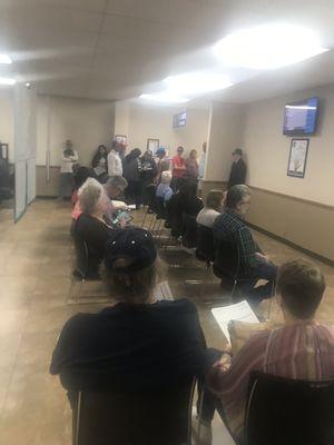 Waiting area; limited chairs that's not a TV that's a screen that shows now serving ticket XXX restrooms are up front. Bring a book to read