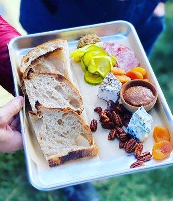 Artisan cheese + charcuterie board featuring locally sourced maine cheeses