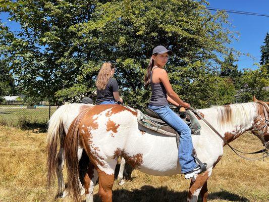 Daughter and niece horseback riding.