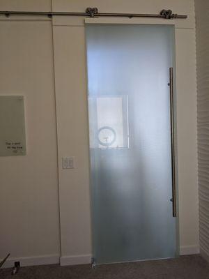 Frosted glass barn door.