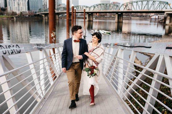 wedding couple walks along the Willamette river in Portland, OR