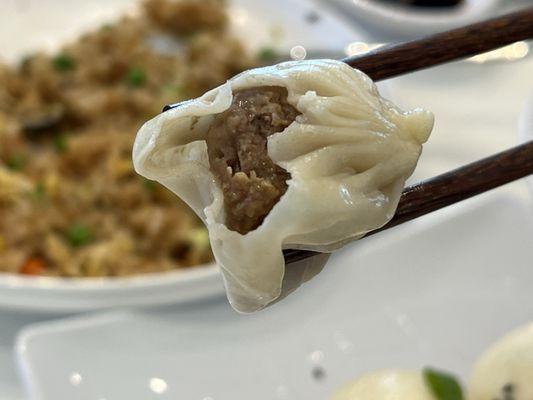 Crab Beef Xiao Long Bao with Shrimp Fried Rice in the background