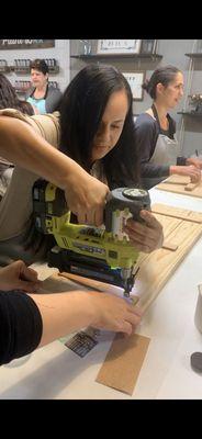 Using the staple gun to put together the wood planks