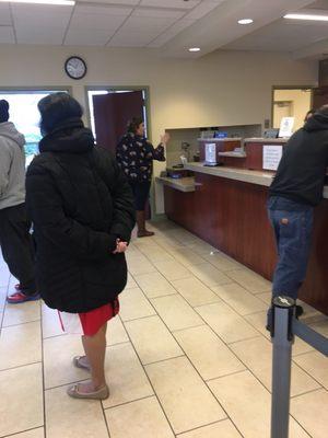 I'm waiting in line and she's talking to two bank tellers behind the counter (no customer service)