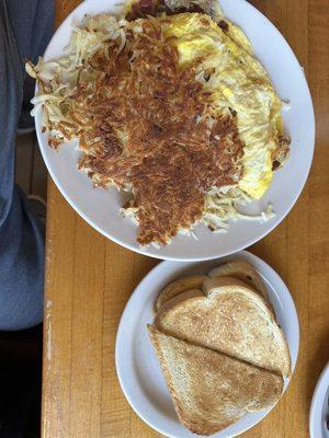 Bacon and Cheese Omelet with overcooked hash browns.