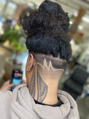 High bald taper with a freestyled "m" design