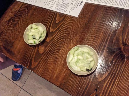 neat free appetizer of cucumbers in a sauce