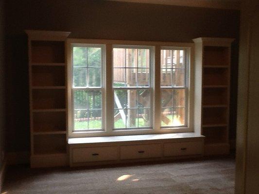 Windows with built in bookcases, and bench seat with storage.