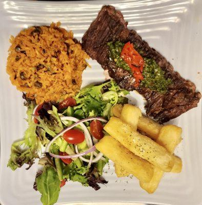 Churrasco (skirt steak) platter with yuca fries, arroz con gandules & home made chimichurri.