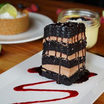 Seven Layer Chocolate Cake: chocolate frosting, hot fudge, maldon sea salt, raspberry coulis