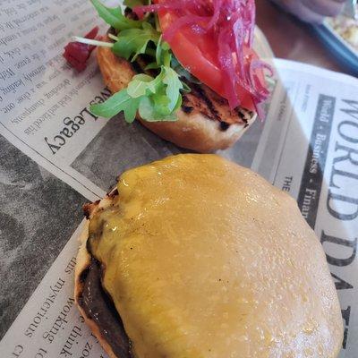 Pastured Beef Burger.  Charbroiled burger on a toasted Brioche Bun with Tomato, Pickled Red Onions, baby Arugula (they have bison too)