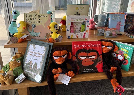 Picture books and their character plushes.