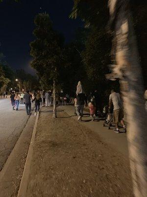 Tons of people walking & going up the hill to their vehicles on the outskirts @ Americafest  Rose Bowl In Pasadena July 4, 2019