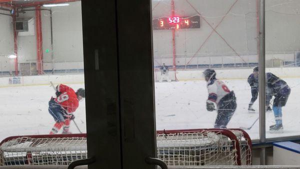 Surprising to watch a hockey game from the sidewalk in Uptown Oakland at midnight on a Thursday.