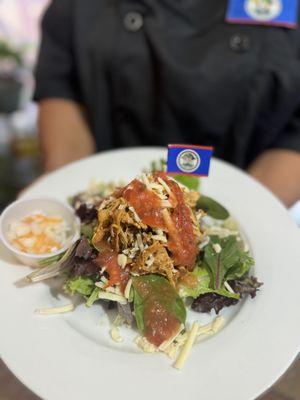 Chicken Salad Bowl - Green salad served with stewed chicken, rice, black beans, our secret cheese sauce and topped with pico de gallo.