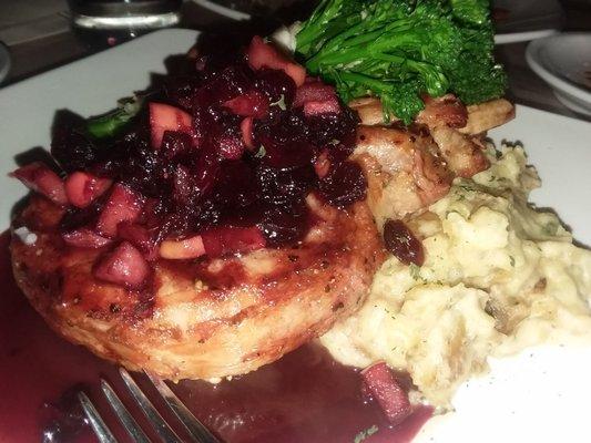 Pork chop over garlic mashed potato smothered in cranapple chutney with a side of prosciutto wrapped broccolini.