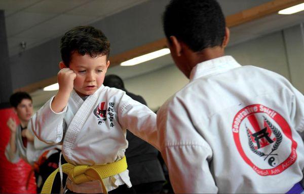 Students learn leadership skill by helping lower belts train.