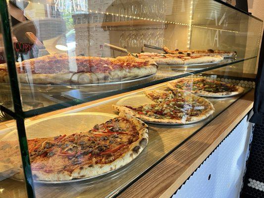 Pizza by the slice at front counter