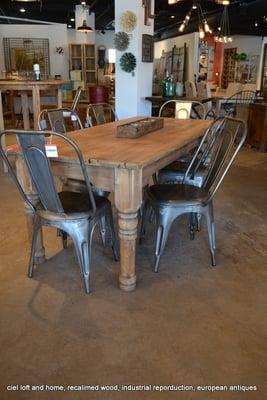 Tolix cafe chairs with a reclaimed wood dining table.