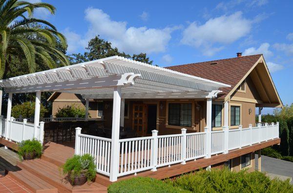 White patio cover with Trex decking and railing