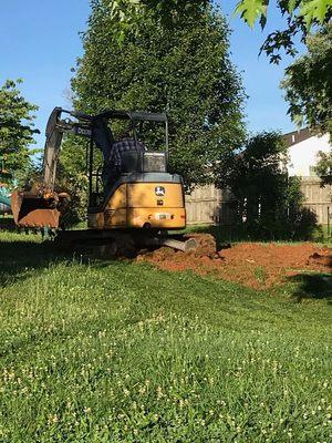 Me cutting ground for a swimming pool