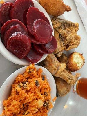 Fried chicken with pickled beets, carrot-raisin salad and hush puppies