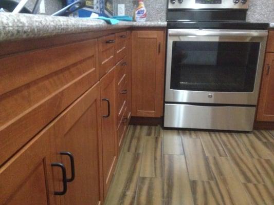 shaker cabinets, granite counters, new stove, and the funky shaped wood looking tiles. I took this kitchen down to almost the...