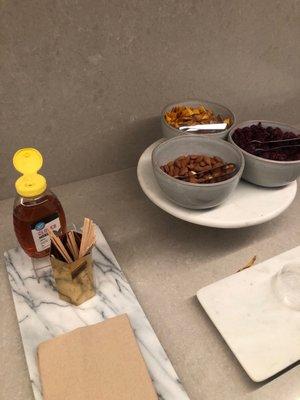 Nuts, dried fruit, hot tea, and water in the lounge area