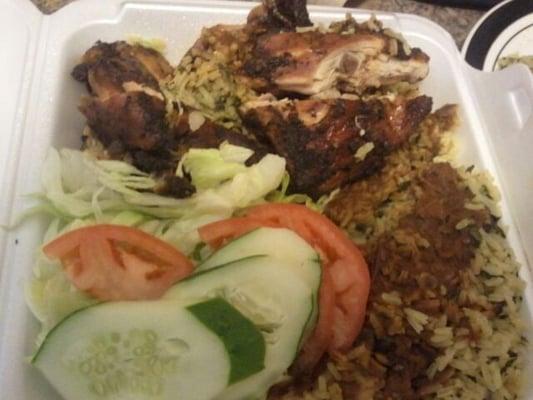 Jerk chicken, rice pilaf and salad.