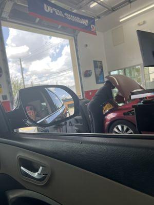 The girl is fixing a car