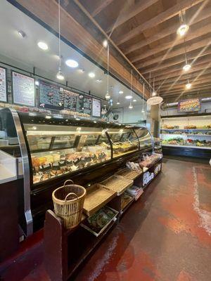 The Deli/Salad display counter and organic produce displayed on the back wall.