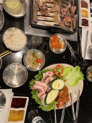 BBQ grill with brisket, chicken bulgogi, and pork belly plus side dishes