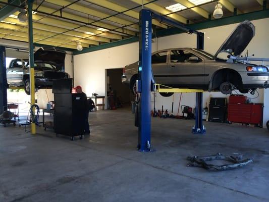 Picture of a couple of vehicles waiting for the transmissions to be rebuilt and reinstalled