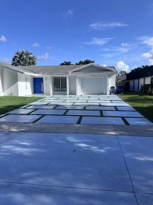 Asymmetrical squares with turf and sealer driveway.