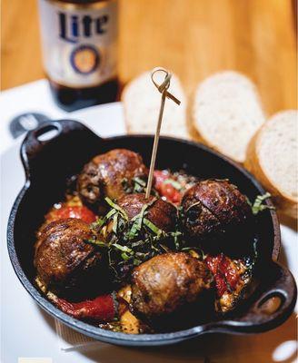 Venison bacon meatballs. So tender and juicy in a tomato stew sauce