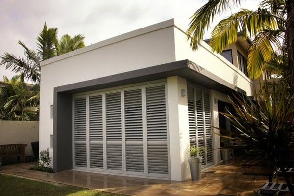 Exterior custom shutters for a beautiful backyard in La Jolla. Aluminum shutters make for great patio additions.