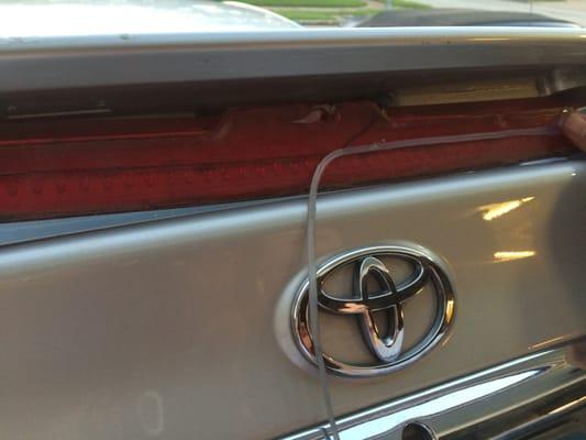 Bad Spoiler Replacement.  Look at the fresh caulk they used!!!