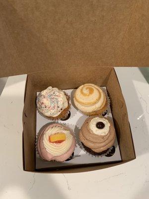 4 cupcakes--French Vanilla Cupcake, Salty Carmella Cupcake, Raspberry Lemonade Cupcake, Chocolatte Cupcake