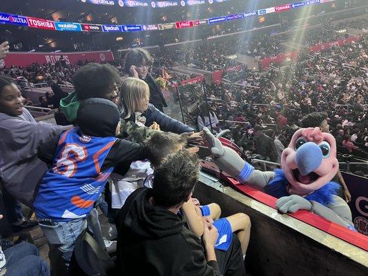 Kids enjoying the game and having fun with the Mascot