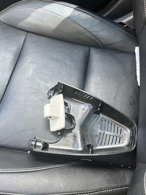 A sun visor clip and rear view mirror housing that fell from the ceiling while driving