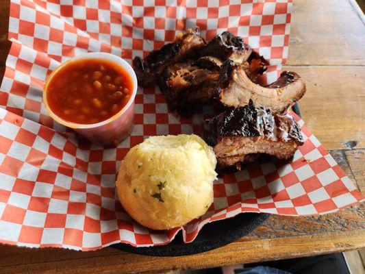 Half Rack rib lunch special with side of beans and a garlic roll.