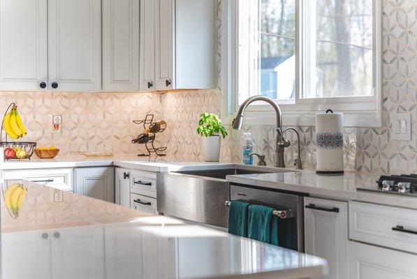 Kitchen remodel in Centreville, VA with wooden flooring and hooded chimney