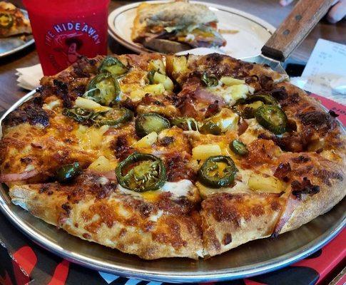 Hurricane - Hideaway red sauce, mozzarella and cheddar cheese, Canadian bacon, smoked bacon, green bell peppers, pineapple and jalapeños.