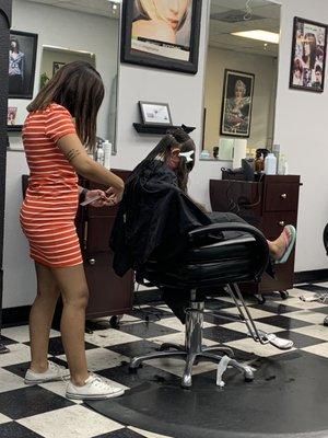 My Daughter getting her hair trimmed by Nadia.